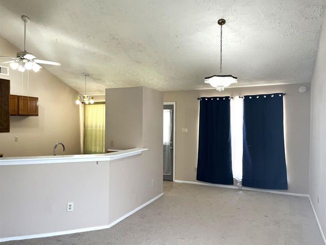 Here's the dining room and a view of the kitchen | Image 7