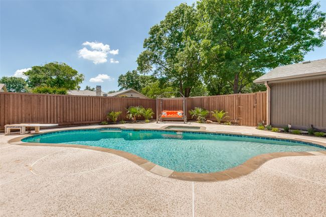 View of swimming pool featuring a fenced backyard, an in-ground hot tub, and a patio area | Image 36