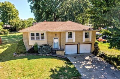 Raised ranch featuring a garage and a front yard | Image 2