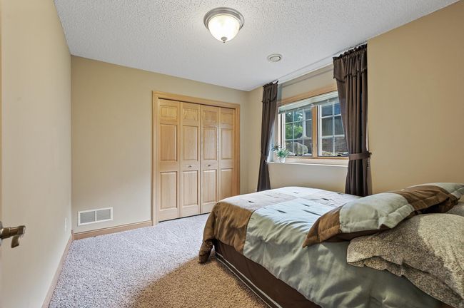 The third bedroom in the home located in the lower level provides a comfortable room for guests and family. Paneled doors continue throughout. | Image 30