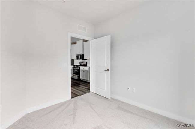 Carpeted empty room with baseboards | Image 24