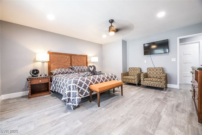 Bedroom featuring light wood-style flooring, baseboards, a ceiling fan, and recessed lighting | Image 27