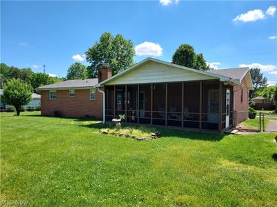 Another shot from the back of the home highlighting the very welcoming screened-in porch. | Image 3