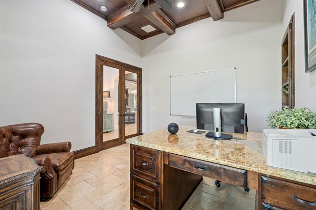 The glass-plated double doors provide a sense of privacy, while still maintaining an open and approachable feel to the Foyer just beyond. With the room being so large, the space can easily accommodate additional seating and storage to help you stay tidy and organized. | Image 8