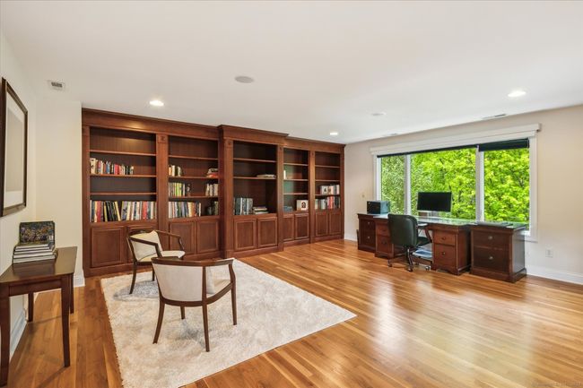 Loft with hardwood floors and built in bookcases. | Image 16