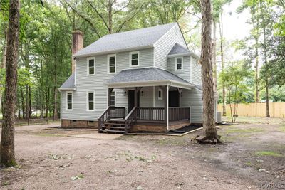 View of front facade with a porch and central air condition unit | Image 1