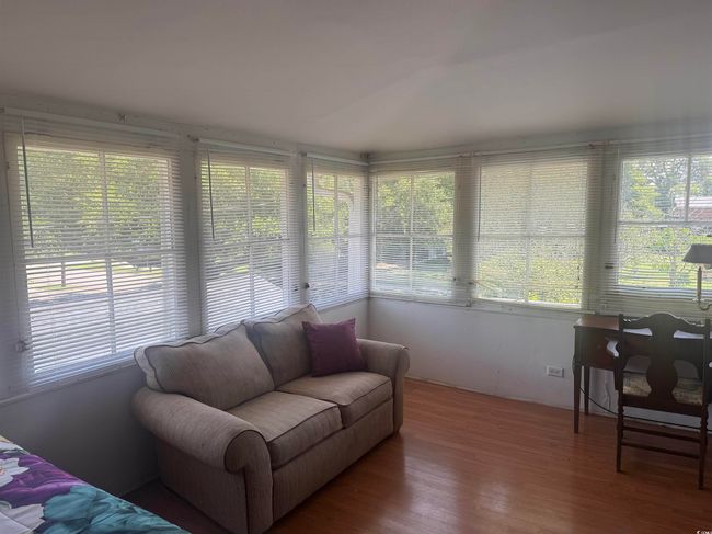 Sunroom / solarium featuring plenty of natural light and wood finished floors | Image 22