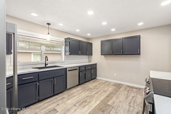 Stainless steel appliances, navy cabinets, black fixtures... all the things pinterest boards are made of | Image 12