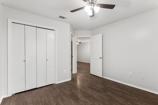 Front bedroom with ceiling fan, closet and private bathroom | Image 15
