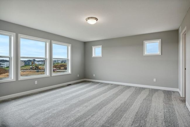 (Photo is of an inventory home, actual homes finishes will vary) Spacious and luxurious primary suite large enough for a California King. Enjoy a private spa-like bathroom and two walk-in closets. | Image 12