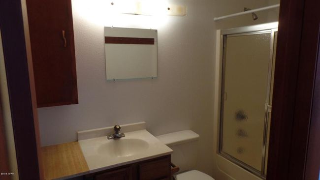 Full bath featuring toilet, vanity, and combined bath / shower with glass door | Image 29