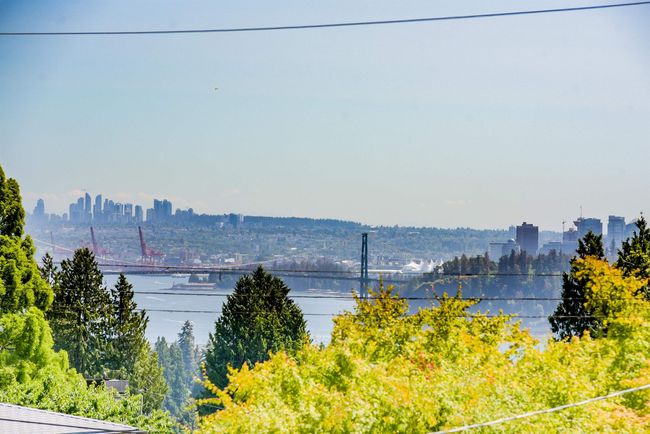 Water view featuring a notable bridge and city skyline | Image 15