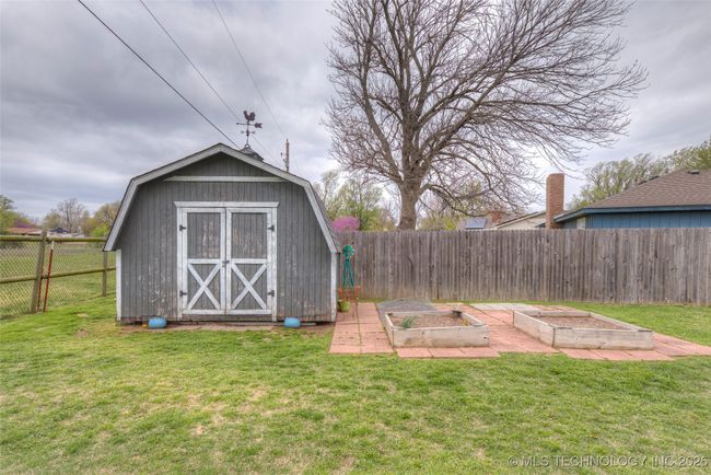 Great spot to store all of your pool equipment, toys and garden needs. There are also two raised beds to grow those tomatoes this summer! | Image 33