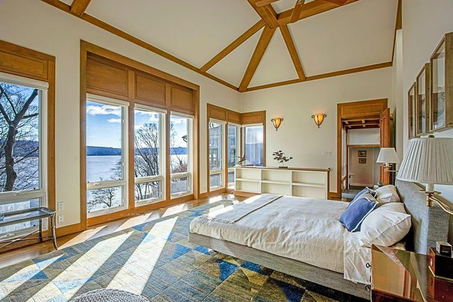 Bedroom with a water view, a spacious closet, and lofted ceiling | Image 21