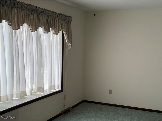 Empty room featuring carpet floors, baseboards, and visible vents | Image 9