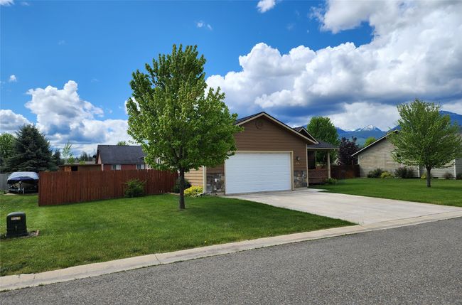 View of front of house with driveway, an attached garage, and a mountain view | Image 49