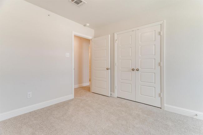 Unfurnished bedroom featuring light colored carpet and a closet | Image 27