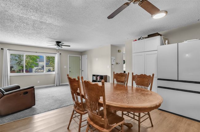 Dining area featuring a ceiling fan, a textured ceiling, light wood-style floors, and baseboards | Image 11
