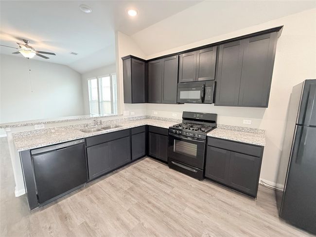 14501 SUGAR PINES DR - Kitchen with all black appliances, refrigerator included | Image 16