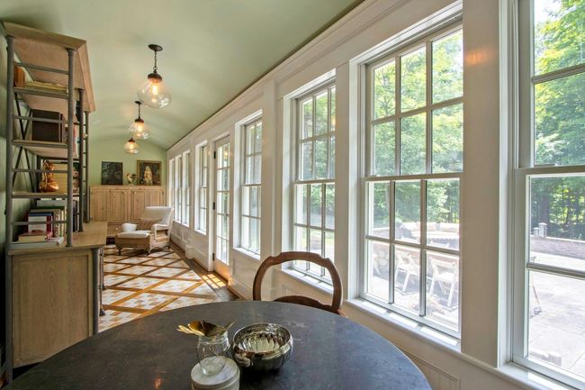 Dining space with healthy amount of natural light, vaulted ceiling, and inlaid floor details | Image 9