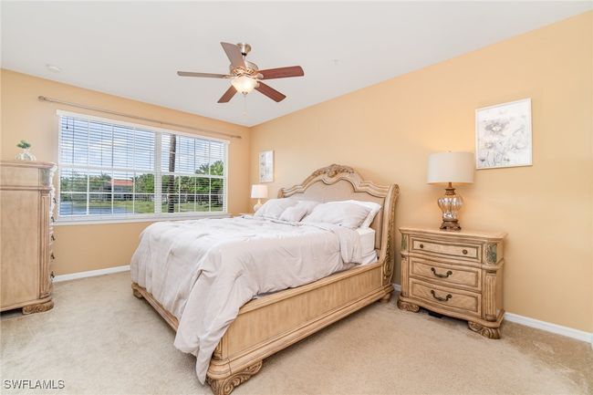 Bedroom with light carpet, baseboards, and a ceiling fan | Image 8