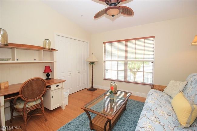 Living room with light wood-type flooring, lofted ceiling, and ceiling fan | Image 9