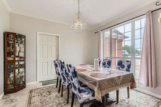 Dining room featuring a chandelier and ornamental molding | Image 7