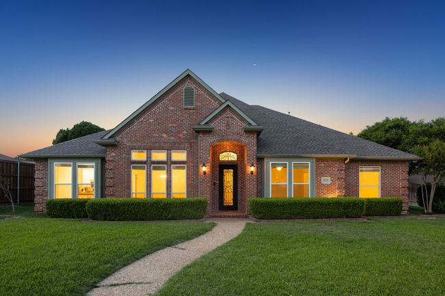 Traditional-style brick home at dusk | Image 30