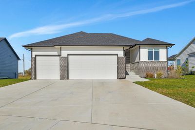 Prairie-style house with a garage and a front lawn | Image 1