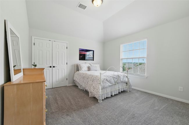Bedroom with carpet floors, lofted ceiling, and a closet | Image 34