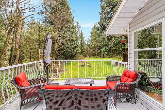 Wooden deck with outdoor lounge area and a lawn | Image 28