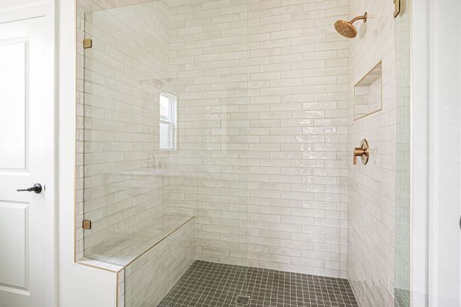 Beautiful tile from floor to ceiling and a bench seat in the primary bathroom | Image 14