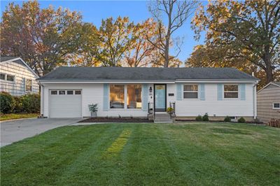 Single story home featuring a front yard and a garage | Image 1