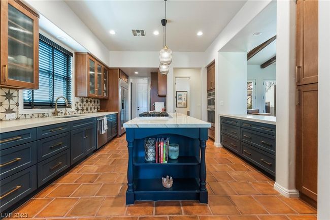 Newly renovated kitchen, new cabinets and counter tops, new island, window and bartop to living room on right, coffee and wine bar into the pantry and laundry room straight back to the left. | Image 8