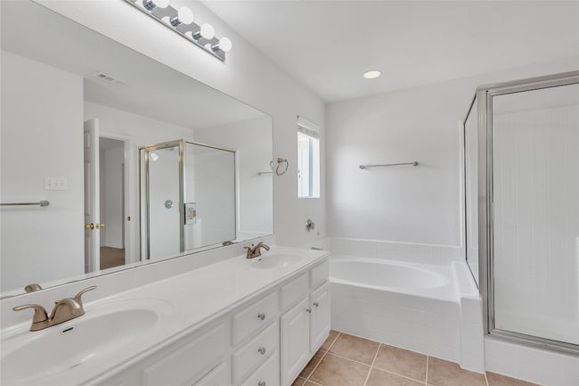 Bathroom featuring a garden tub, a shower stall, double vanity, tile patterned floors, and recessed lighting | Image 22