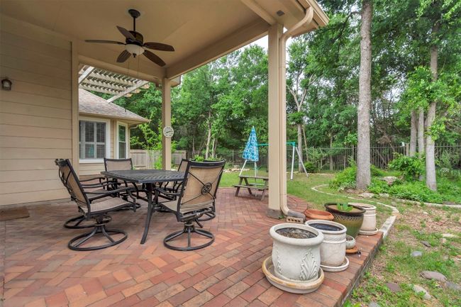 View of patio / terrace with outdoor dining area, a fenced backyard, and ceiling fan | Image 11