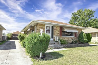 View of front of property with a front yard and a garage | Image 2