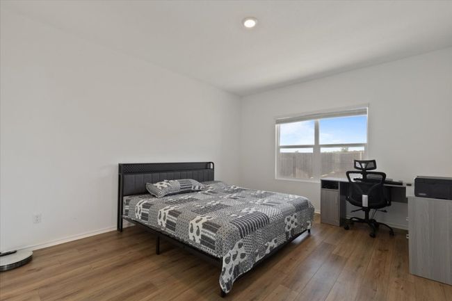 Bedroom with baseboards and wood finished floors | Image 7