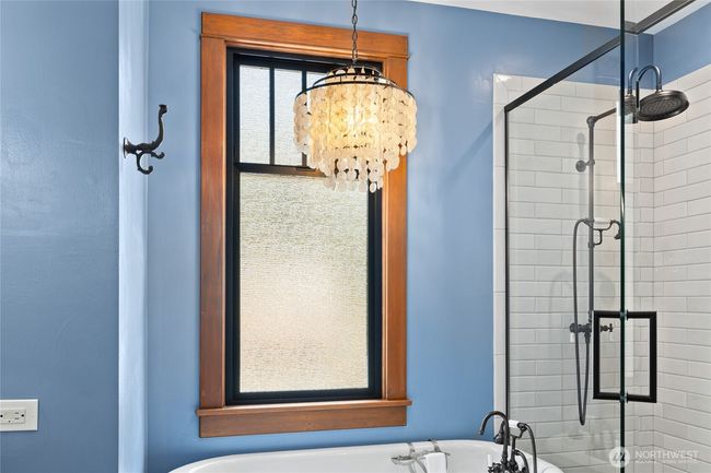 Topping it all off is a striking chandelier, bringing elegance and a touch of whimsy to this one-of-a-kind bath retreat. | Image 26