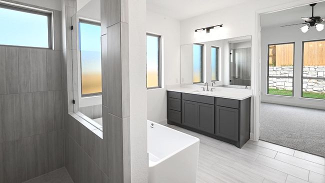 Full bath featuring a walk in shower, vanity, a soaking tub, and ceiling fan | Image 21