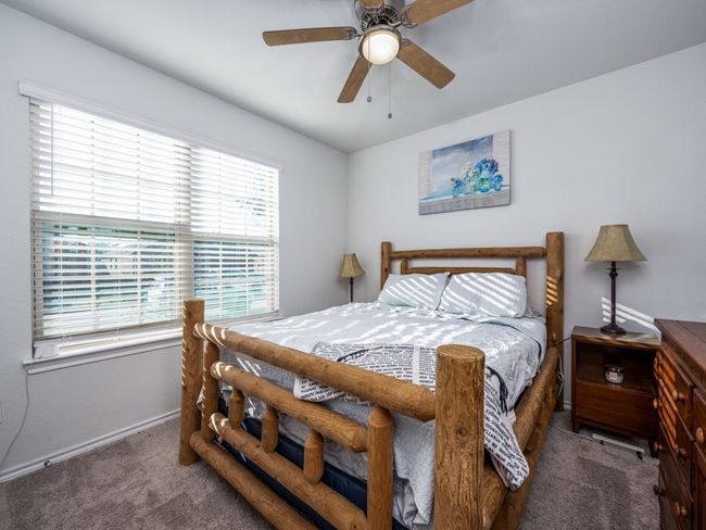 Bedroom featuring carpet, multiple windows, and a ceiling fan | Image 21