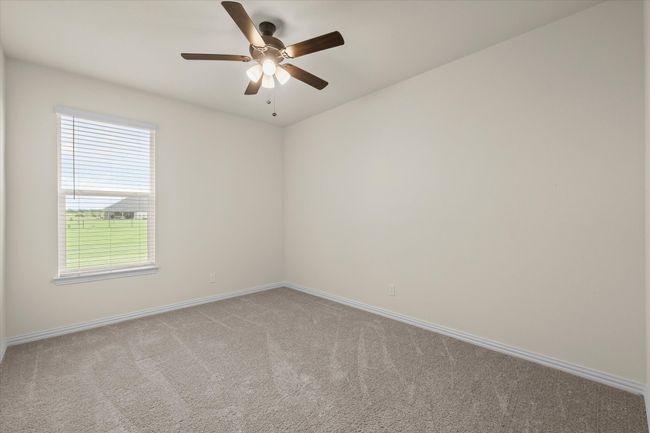 Unfurnished room featuring light colored carpet and ceiling fan | Image 18