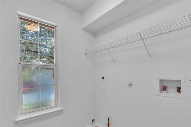 Laundry area featuring hookup for a washing machine, gas dryer hookup, and electric dryer hookup | Image 15