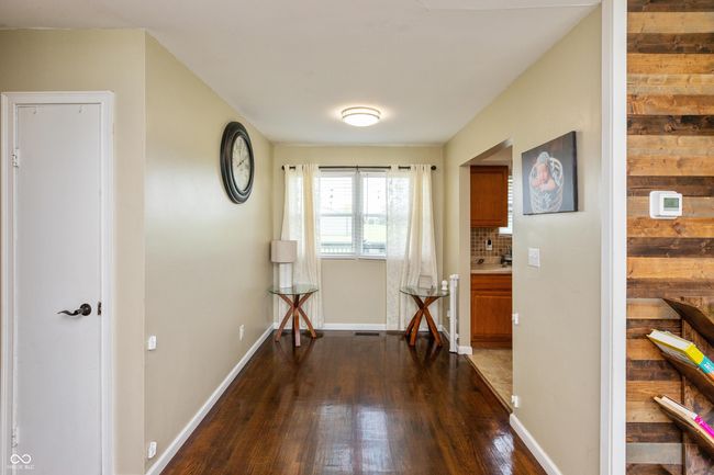 corridor featuring dark wood finished floors and baseboards | Image 7
