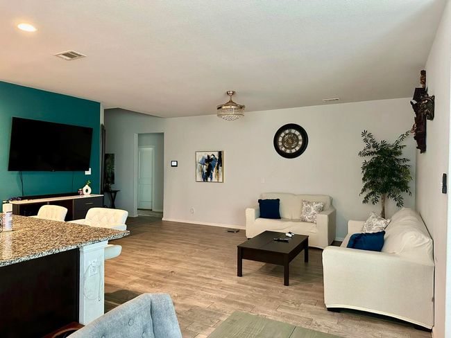 Living area featuring wood finished floors and baseboards | Image 13