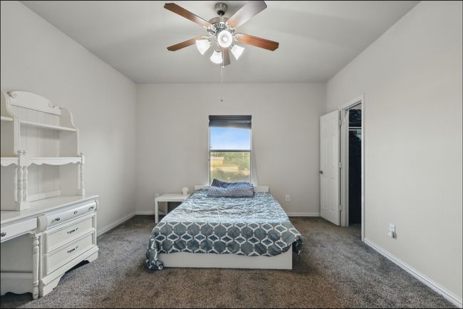 Bedroom with carpet flooring, lofted ceiling, and ceiling fan | Image 32