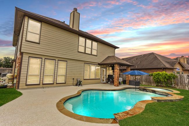 This backyard features solid board fencing providing more privacy. | Image 20