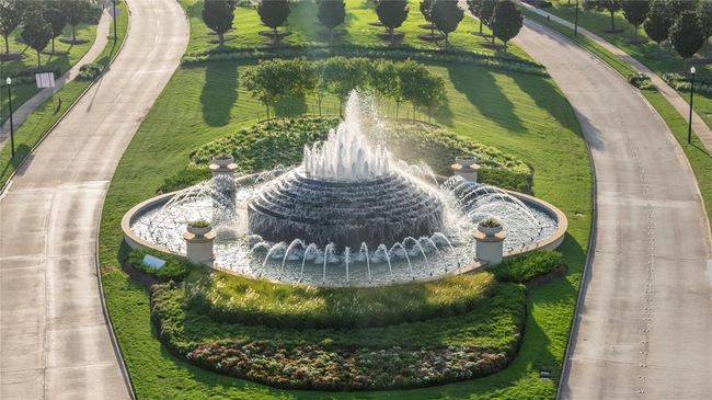 The entrance to Tamarron is marked by a striking large layered fountain, creating a welcoming and tranquil atmosphere. Surrounded by carefully landscaped greenery, the fountain adds both visual appeal and a soothing sound of flowing water. The thoughtful landscaping enhances the entrance, with lush plants and well-placed features that complement the natural beauty of the fountain, making it a peaceful and elegant first impression for anyone entering the community. | Image 20