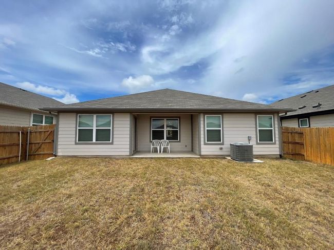 Rear view of house with cooling unit, a patio area, and roof with shingles | Image 19