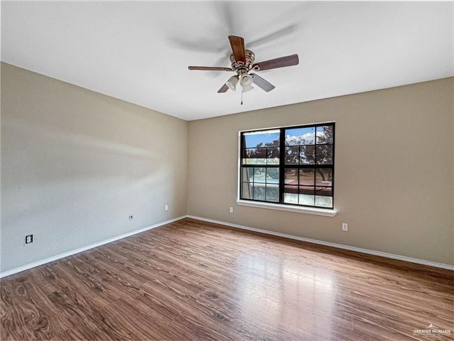 Empty room featuring ceiling fan and wood-type flooring | Image 10